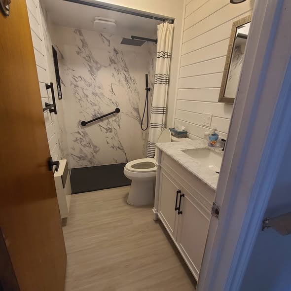Accessible bathroom after: walk-in shower with grab bar