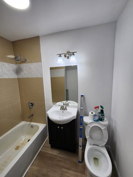 Finished bathroom with dark vanity and new flooring